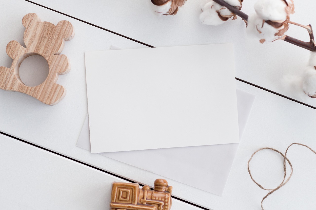A blank cream flatlay with a wooden ring, ready for a brand to take shape